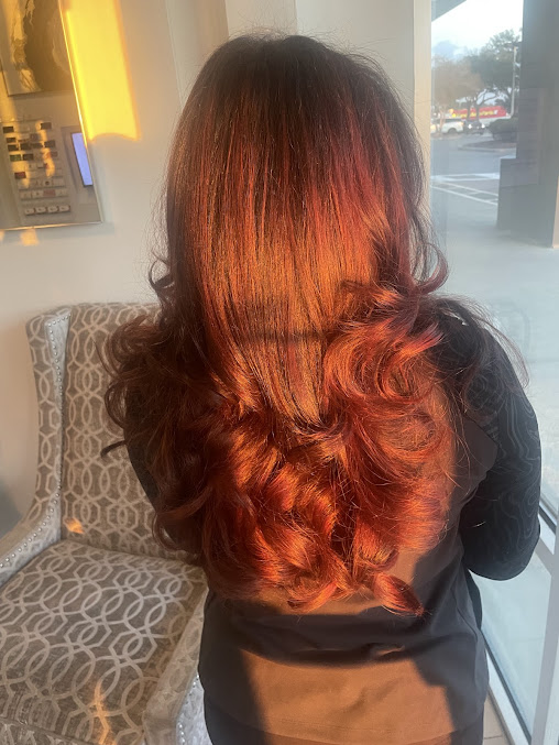 Woman smiling with long strawberry blonde hair